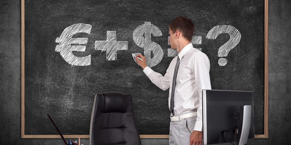 businessman in office drawing money formula on blackboard